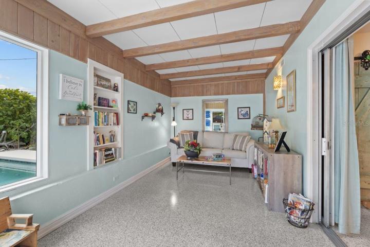 Family room located off the kitchen featuring decorative beams, and 180 degree views of the back yard oasis.
