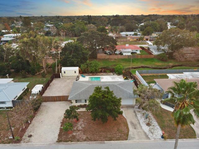 Aerial of the front elevation showing the extended driveway, and property size.