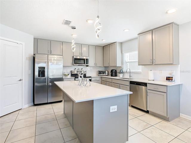 Kitchen View Showing Appliances, Island and Closet Pantry.