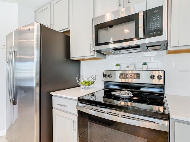 Stainless Steel Refrigerator and Glass Top Stove.