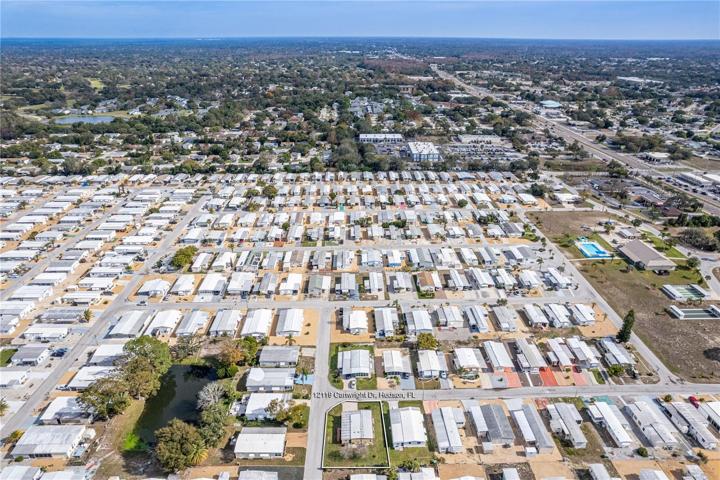 From this photo you can see the approx. property lines of 12119 Cartwright and the community center on right and SR 52 to the right of that looking East.