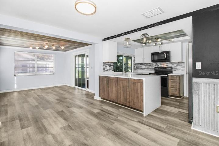 View of kitchen and eat in space and formal dining area that can be also turned into a 3rd bedroom/flex space/2nd living area, if desired