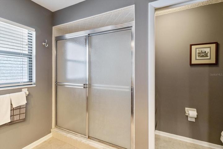 Tiled Shower & Water Closet to the Right