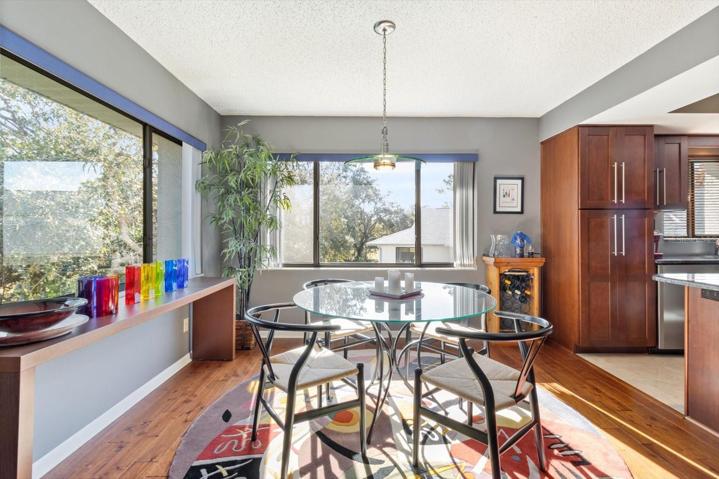 Dining Room w/ 2 Sets of Large Sliding Windows.. Check out the Wishbone Chairs