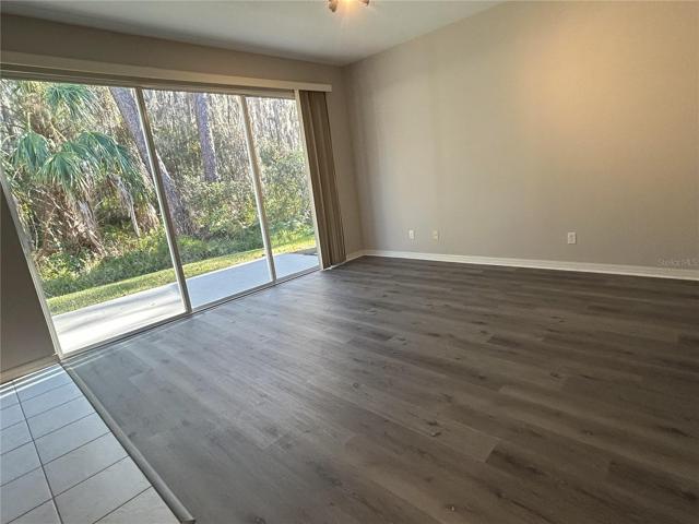 Family Room with Triple Sliders that open up to a private patio & conservation