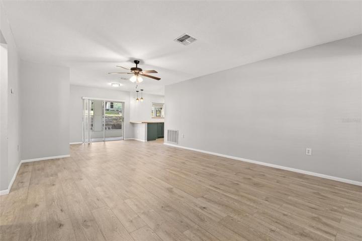 entry walking up to kitchen showing sun room