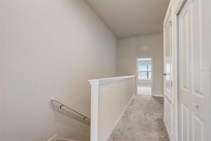 Upstairs landing area with closet laundry