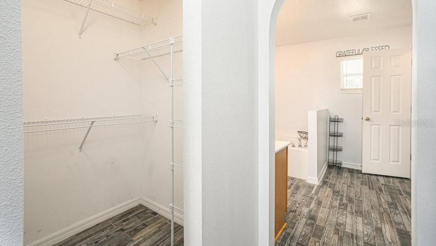 Primary bedroom boasts two walk-in closets