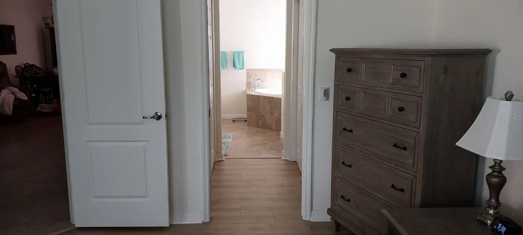 New Laminate Flooring in Main Suite hallway and in His & Hers closets