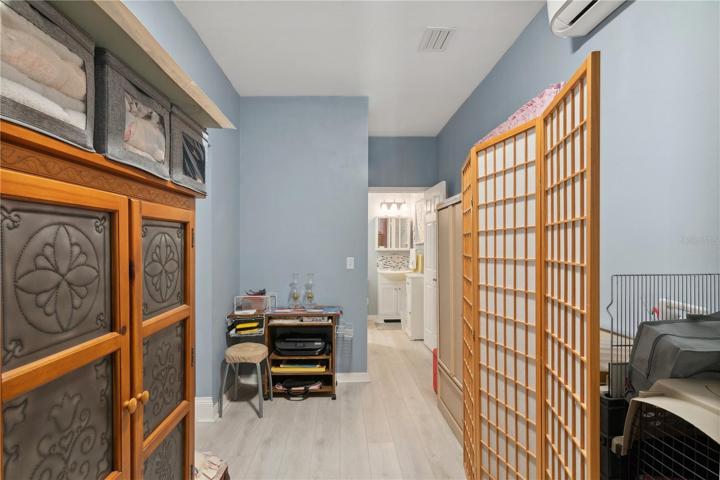 primary bedroom used as storage for now leads to the bathroom