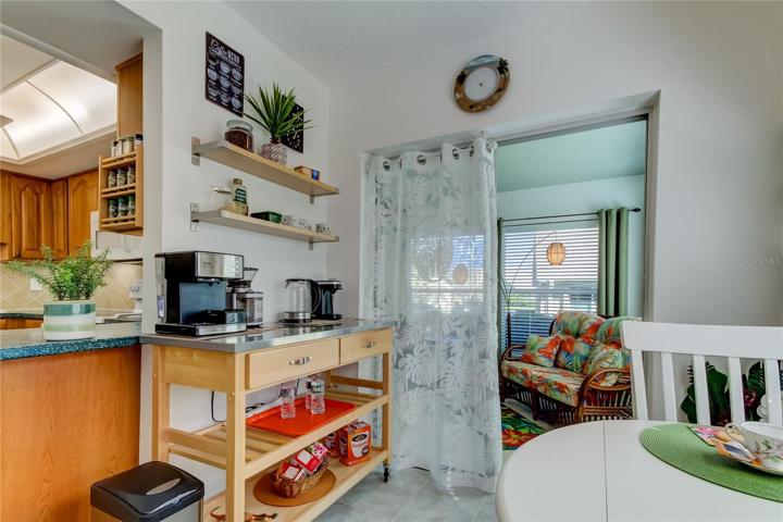 Eat In Section of Kitchen Features Double Sliding Doors into a HUGE Enclosed Lanai!