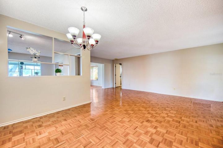Dining area opening to family room with custom shelving~