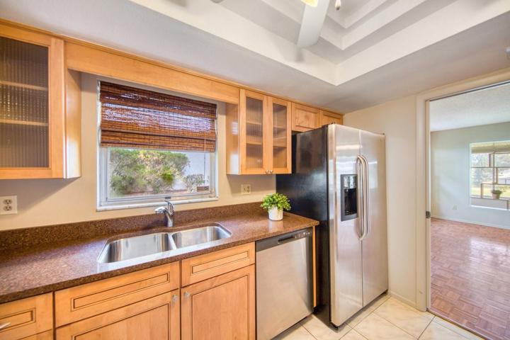 Textured glass door wall cabinets on both sides of window~