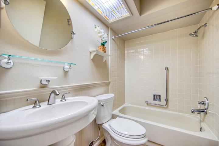 Guest bathroom with tub shower also has safety bar~