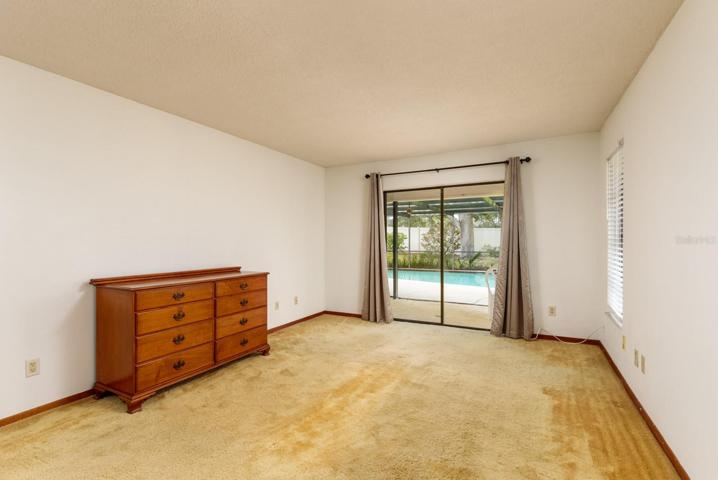 Primary Bedroom with access to Lanai and Pool Deck