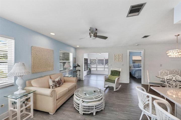 Family Room off kitchen open to light filled Florida Room