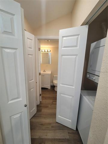 Facing bathroom; left side linen closet; right side laundry closet with washer/dryer and Tankless water heater