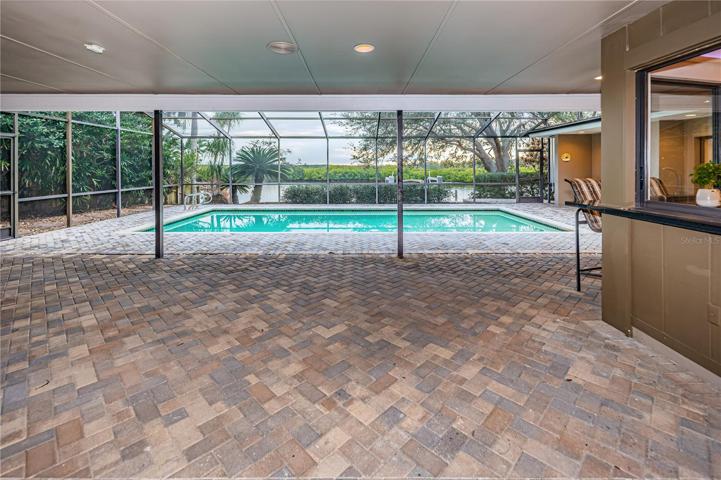 Living room opens wide to the lanai and waterfront.