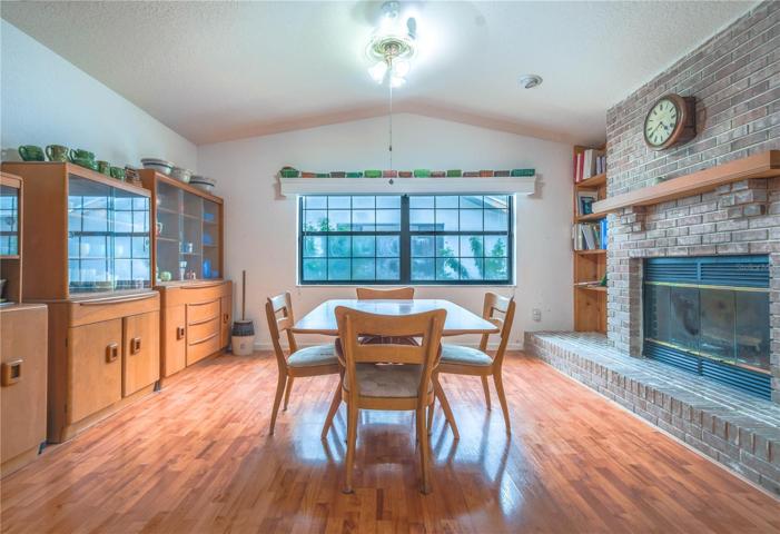 A warm and cozy family room with vaulted ceiling and fireplace.