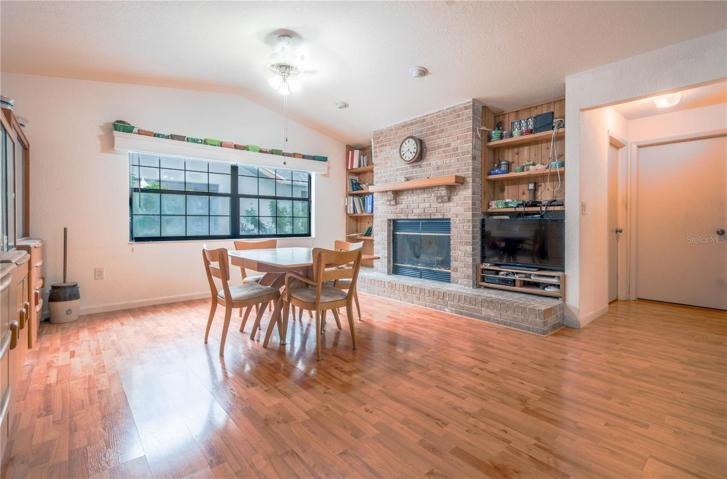 The Family Room has a wood-burning fireplace with a  brick hearth, wood mantle and built-in shelving.