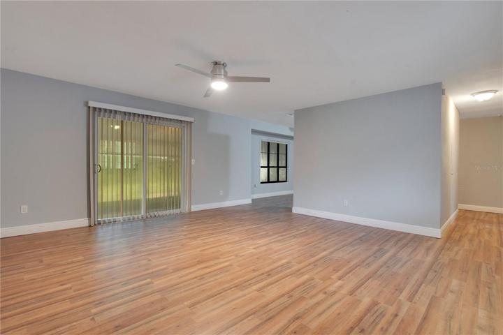 ENTRY TO LIVING ROOM WITH NEW LAMINATE FLOORS/FIXTURES.