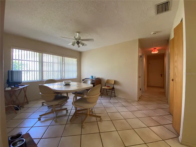 Hall leads to garage straight ahead. Linen closet, guest bedroom on left and closet pantry and 2nd bathroom on right