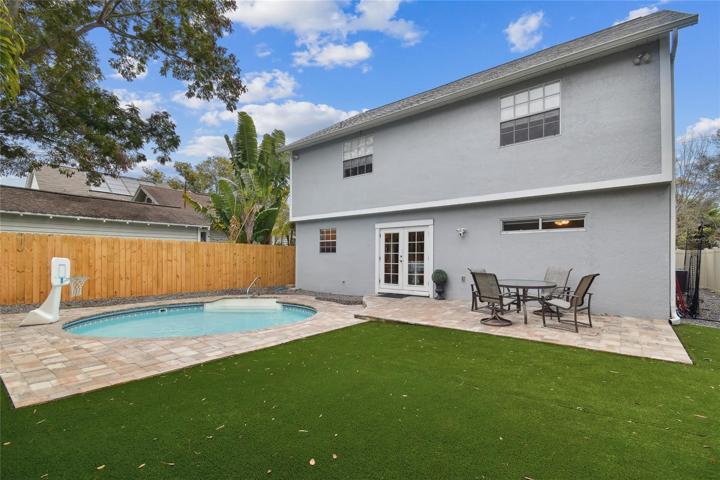 Backyard with new Turf grass system, new pavers and a sparkling pool!