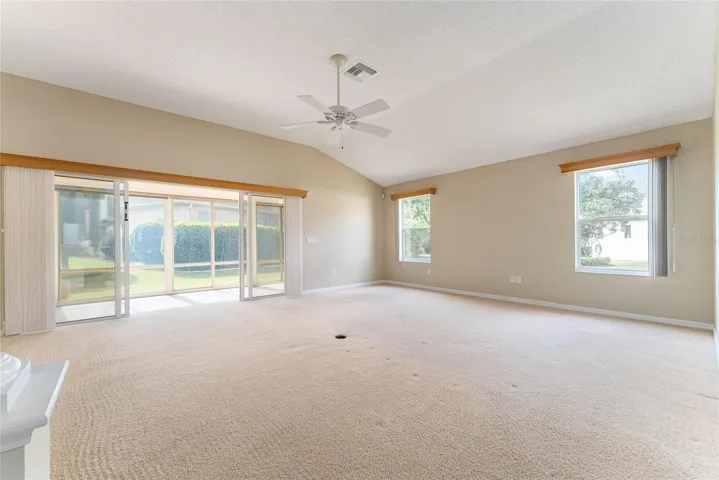 LIVING ROOM w/ SLIDING GLASS DOORS to ENCLOSED LANAI