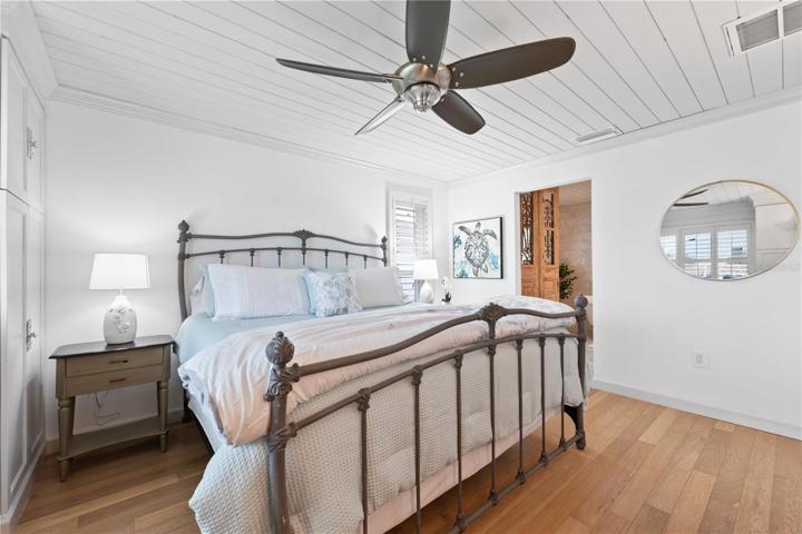 views into the primary master bedroom into the ensuite bathroom with a solid wood door