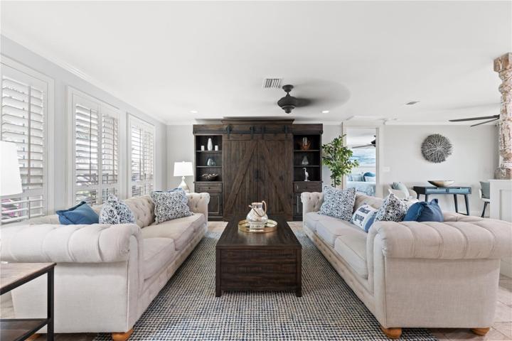open concept gathering area as you walk in the front door decorated in light colors and coastal blues ,,,,