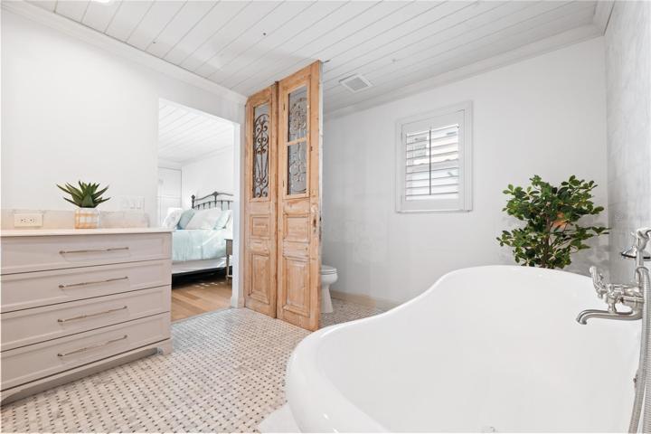 unique custom door divides the toilet area from the tub area