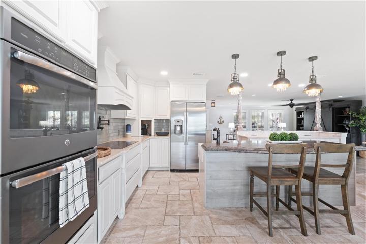 built in double wall oven and island with snack area