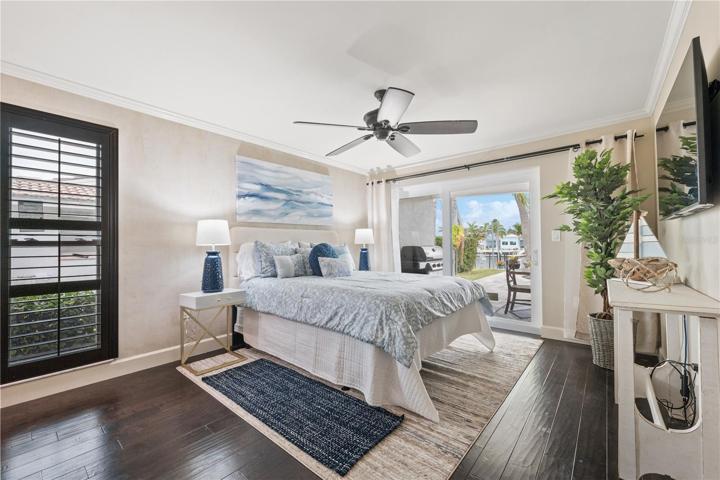 second master bedroom suite ,with views and walk out to the pool decorated in peaceful blues and cream colors