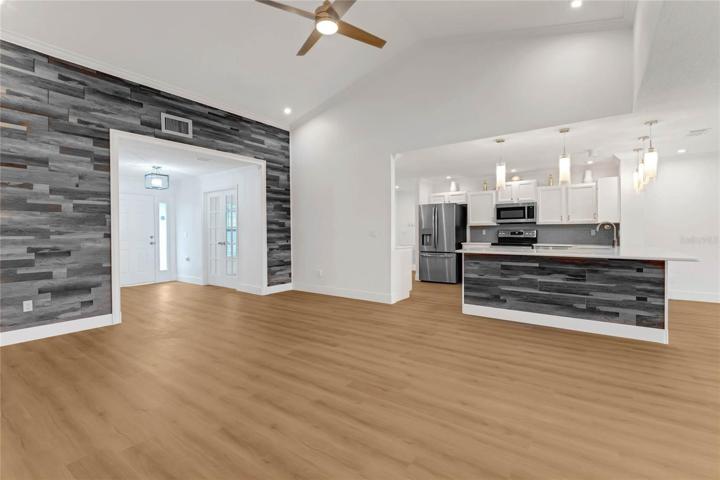 Family room area open to kitchen with accent walls