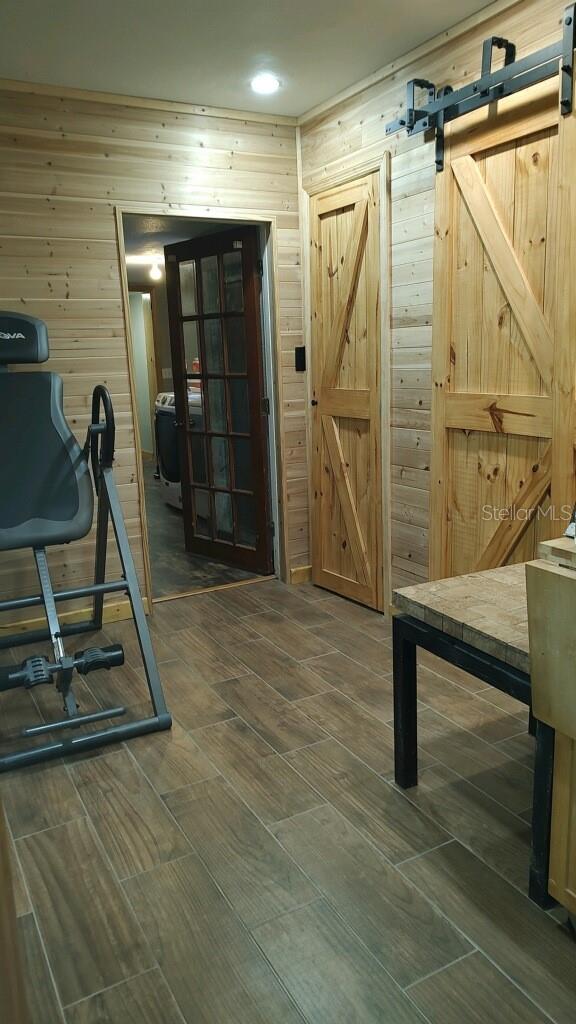 Walk thru with wall of storage and guest bathroom leads into large utility room and Primary and Office/guest room