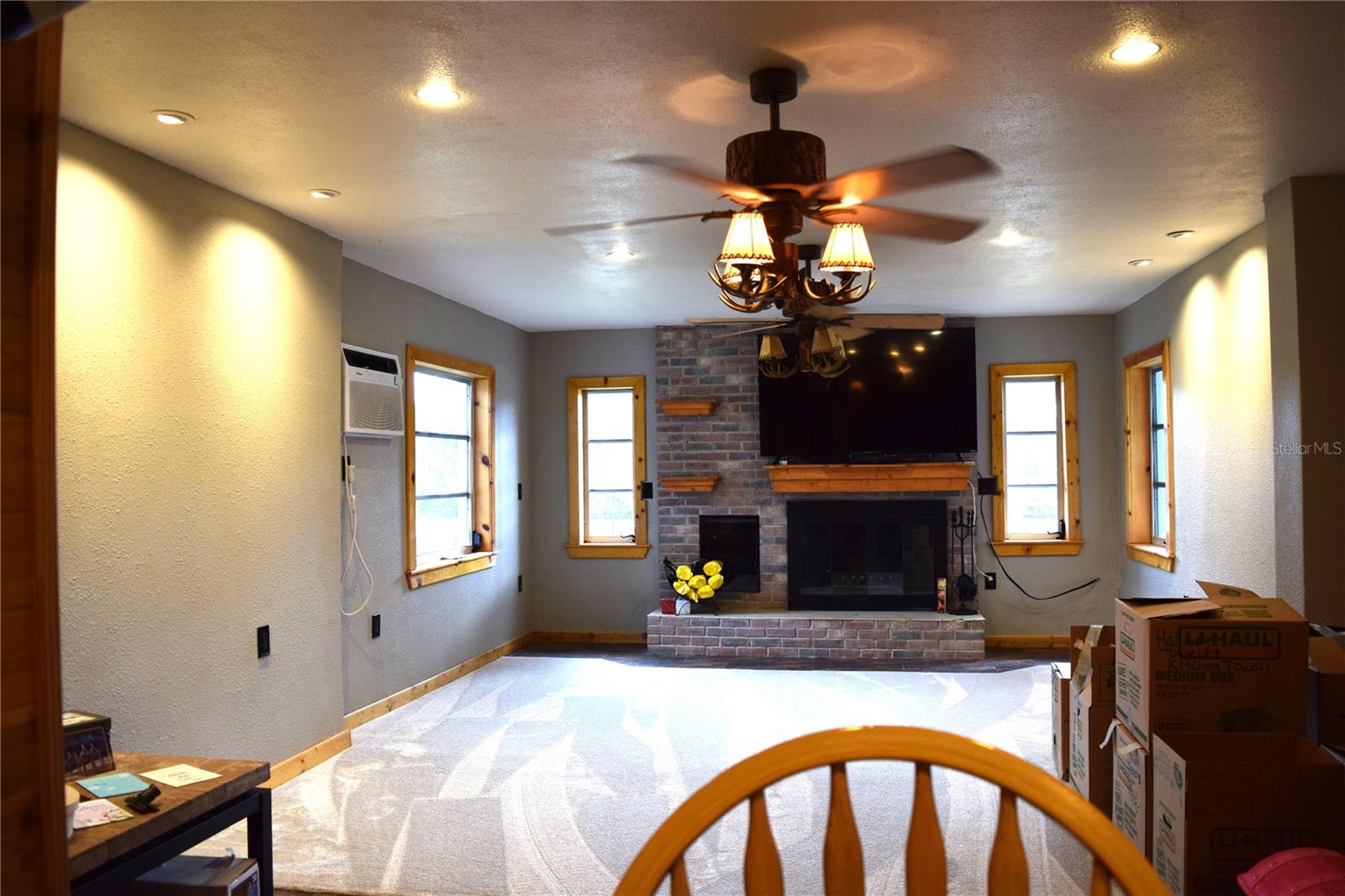 Kitchen bar overlooks great room and wood burning fireplace
