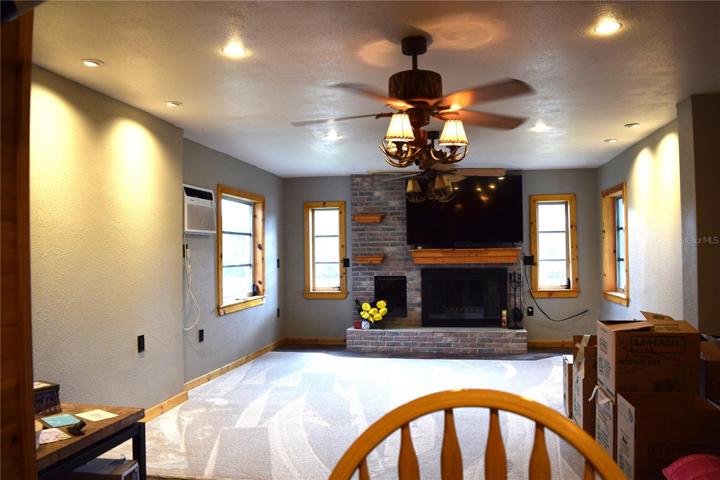Kitchen bar overlooks great room and wood burning fireplace
