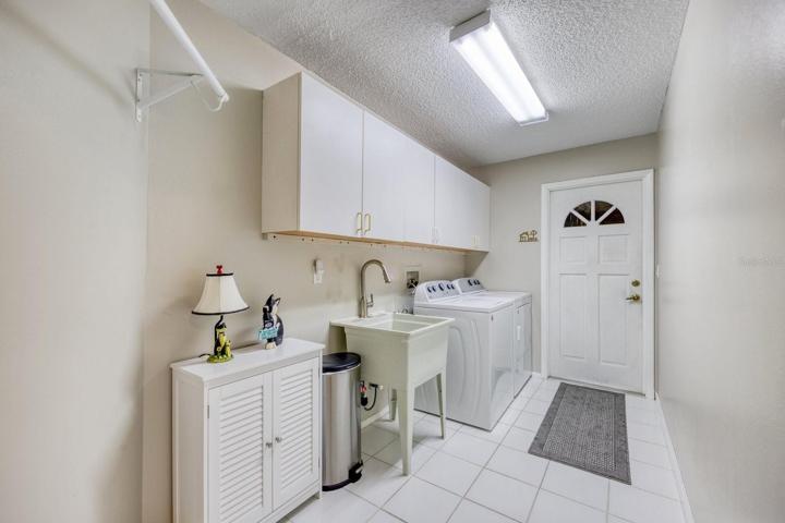 Generous laundry room utility sink & garage access~