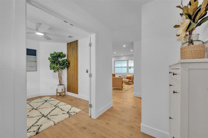 Upon entering the home your greeted with the custom built-in shoe rack, and those warm laminate wood floors.
