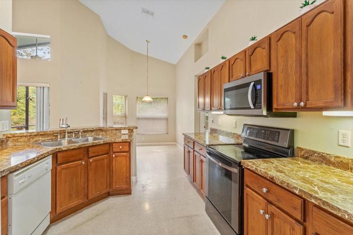 Looking through the Kitchen to the dinette area overlooking the back yard