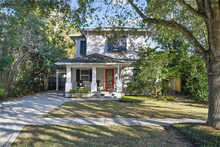 Inviting cottage style front entry. Oversized, roofed carport to the left with the backdoor leading into the drop zone.