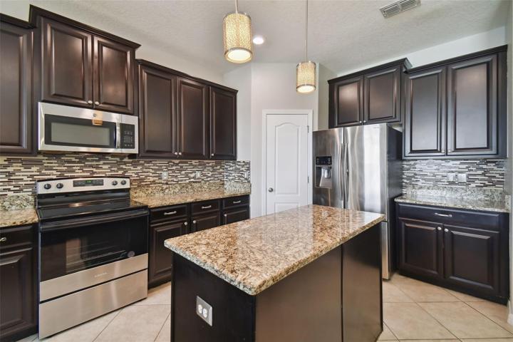 Kitchen with center island. Plenty of cabinetry.