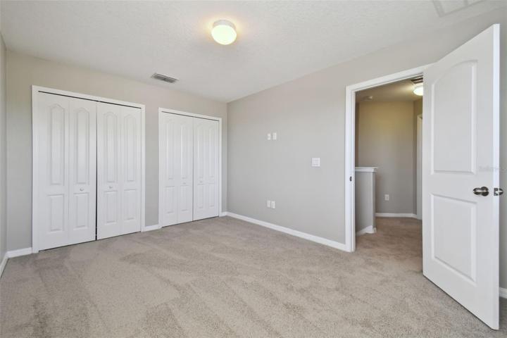 Bedroom 2 which is adjacent to the second bathroom.
