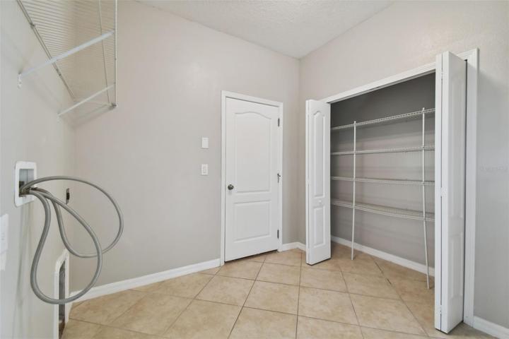 Large Laundry room with storage closet.