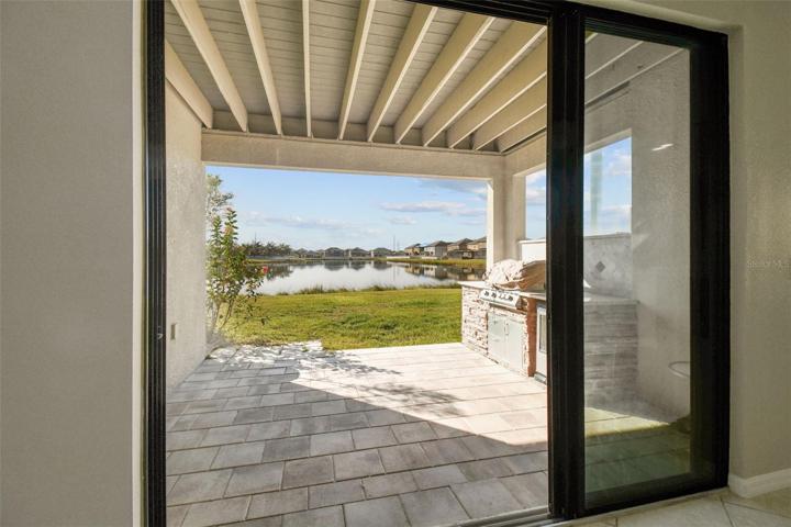 Triple sliding doors lead to the covered paved patio.