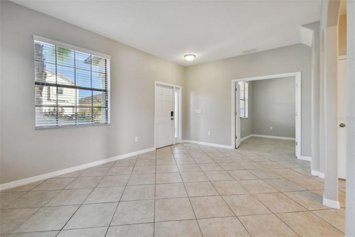 Family room with view towards front entrance and the den/office.
