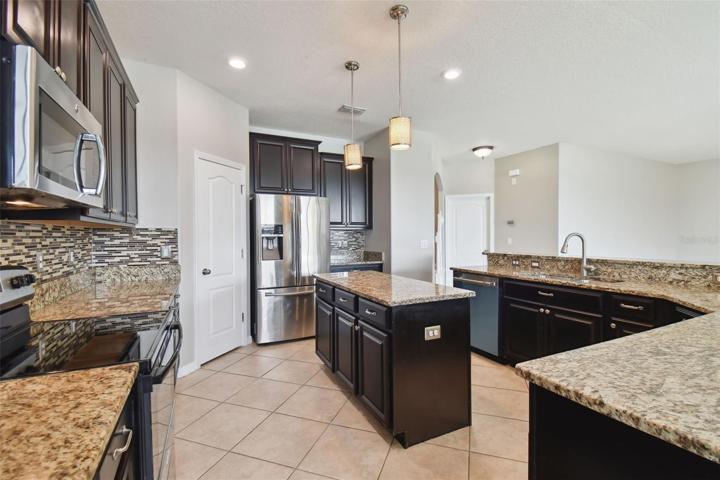 Kitchen view with a new oven and dishwasher.