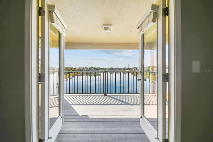 View from the entertainment room out to the covered balcony.