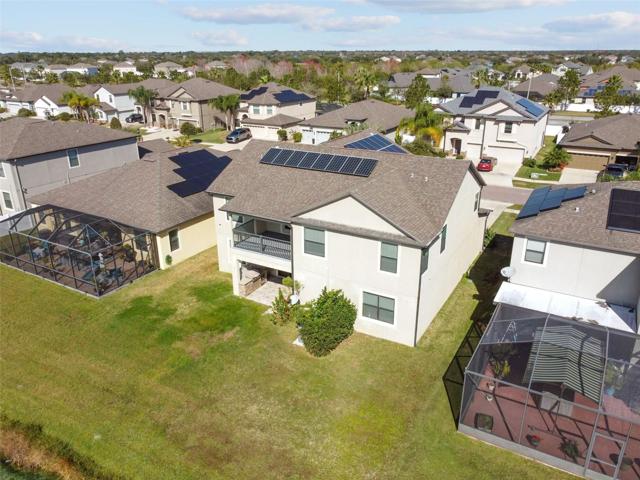 Aerial view of the rear of the home with covered balcony on the second floor.