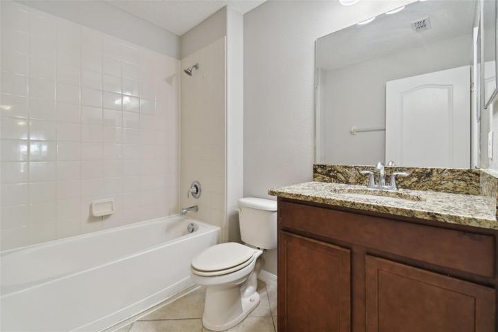 Bathroom 2 with granite sink and tub.